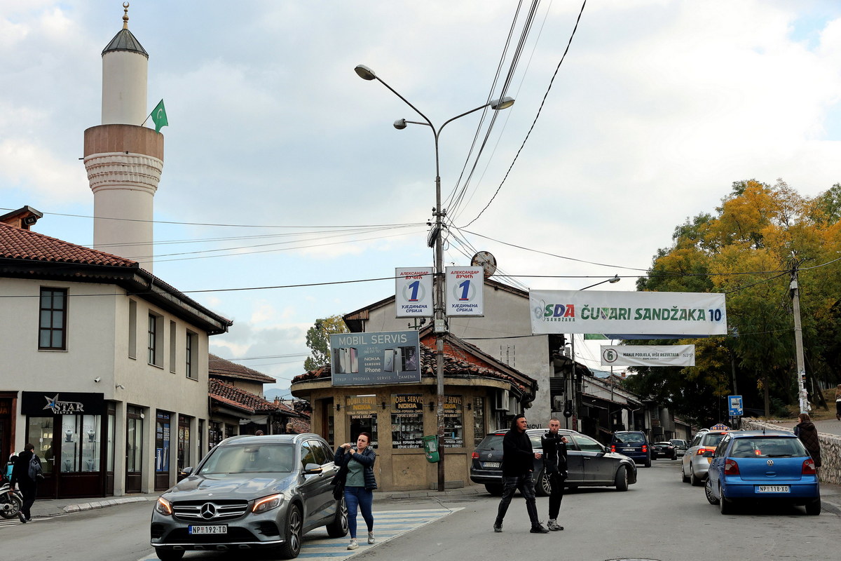 Citizens of Novi Pazar walk past pre-election posters of minority Bosniak parties in the center of Novi Pazar.
